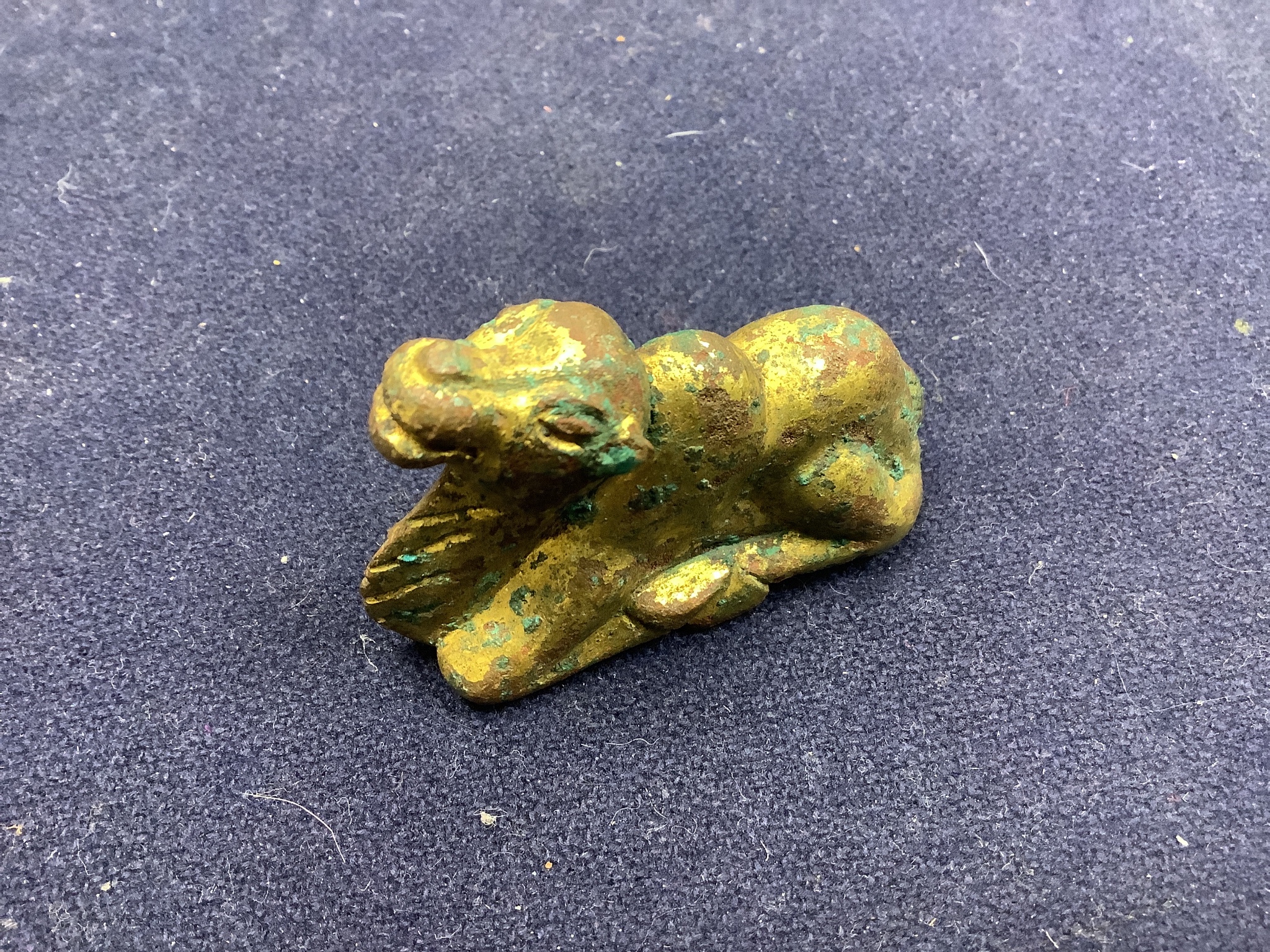 A Chinese gilt bronze figure of a kneeling camel, Han or later